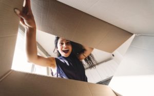 woman looking into cardboard box