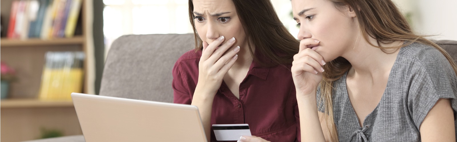 friends worried looking at laptop