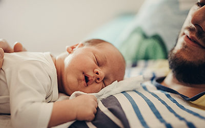 father and baby sleeping