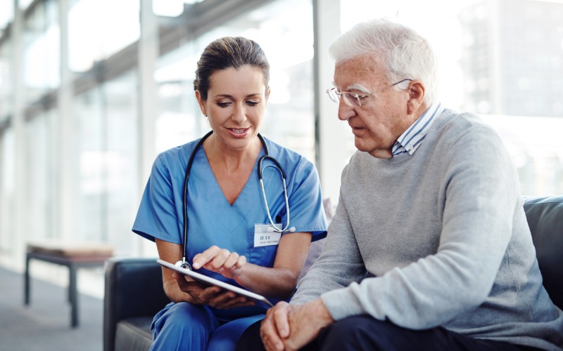 medical professional speaking with older man