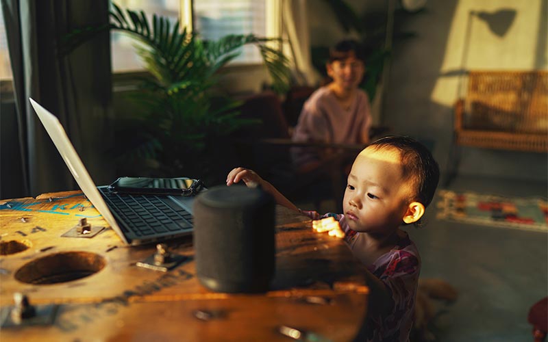 small kid interacting with smart speaker