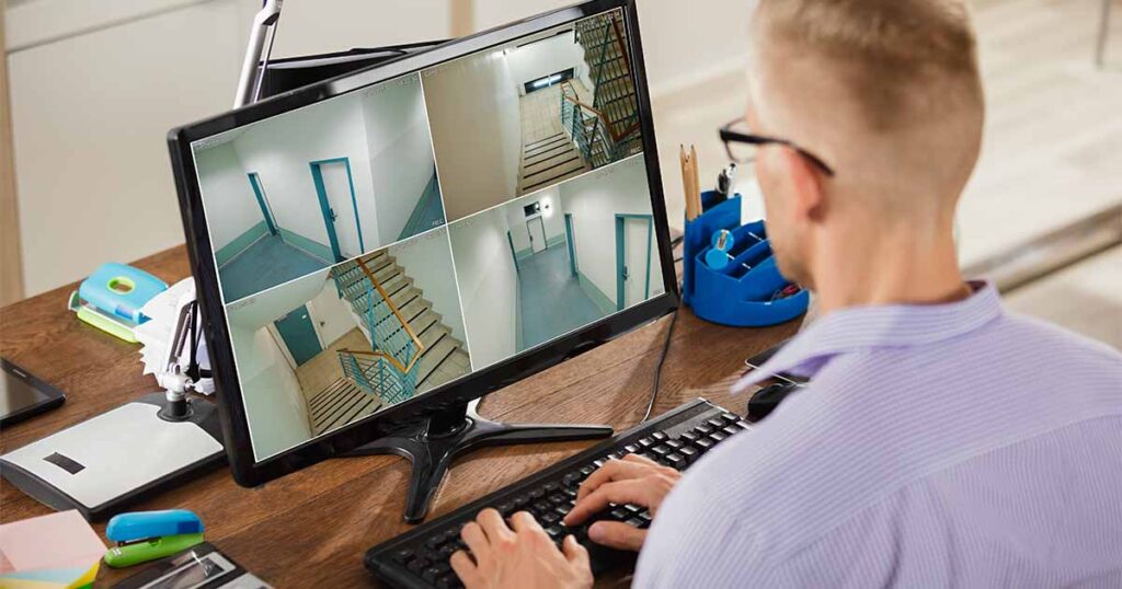 man monitoring security camera feeds