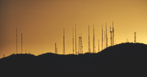 cell towers lined up against the sky