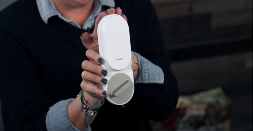 person holding simplisafe lock