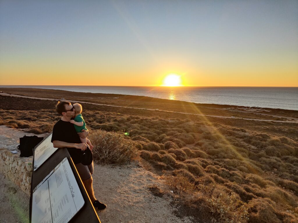 Author's family looking at a sunset over the sea