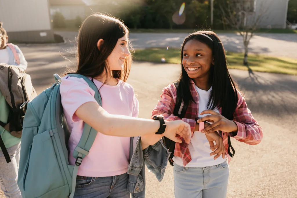 Two little girls wearing the JrTrack 4