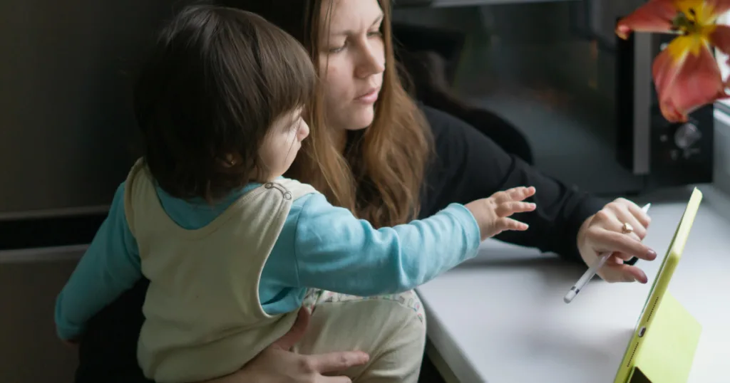 Toddler reaching for tablet