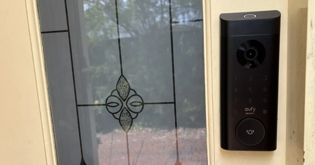 Eufy Video Door Lock installed on a beige front door with a decorative window